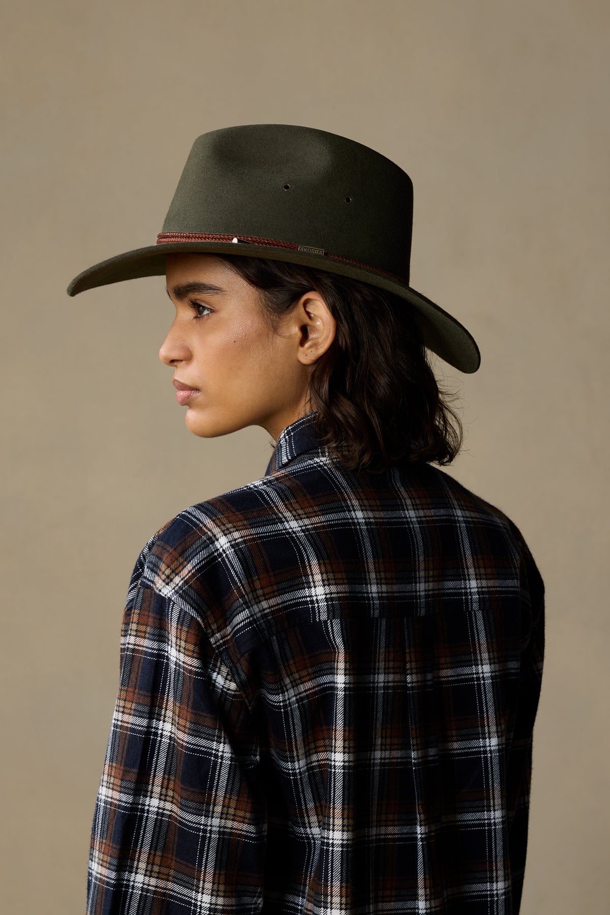 Fern rabbit fur Traveller hat worn by person in plaid shirt, side profile view against neutral background