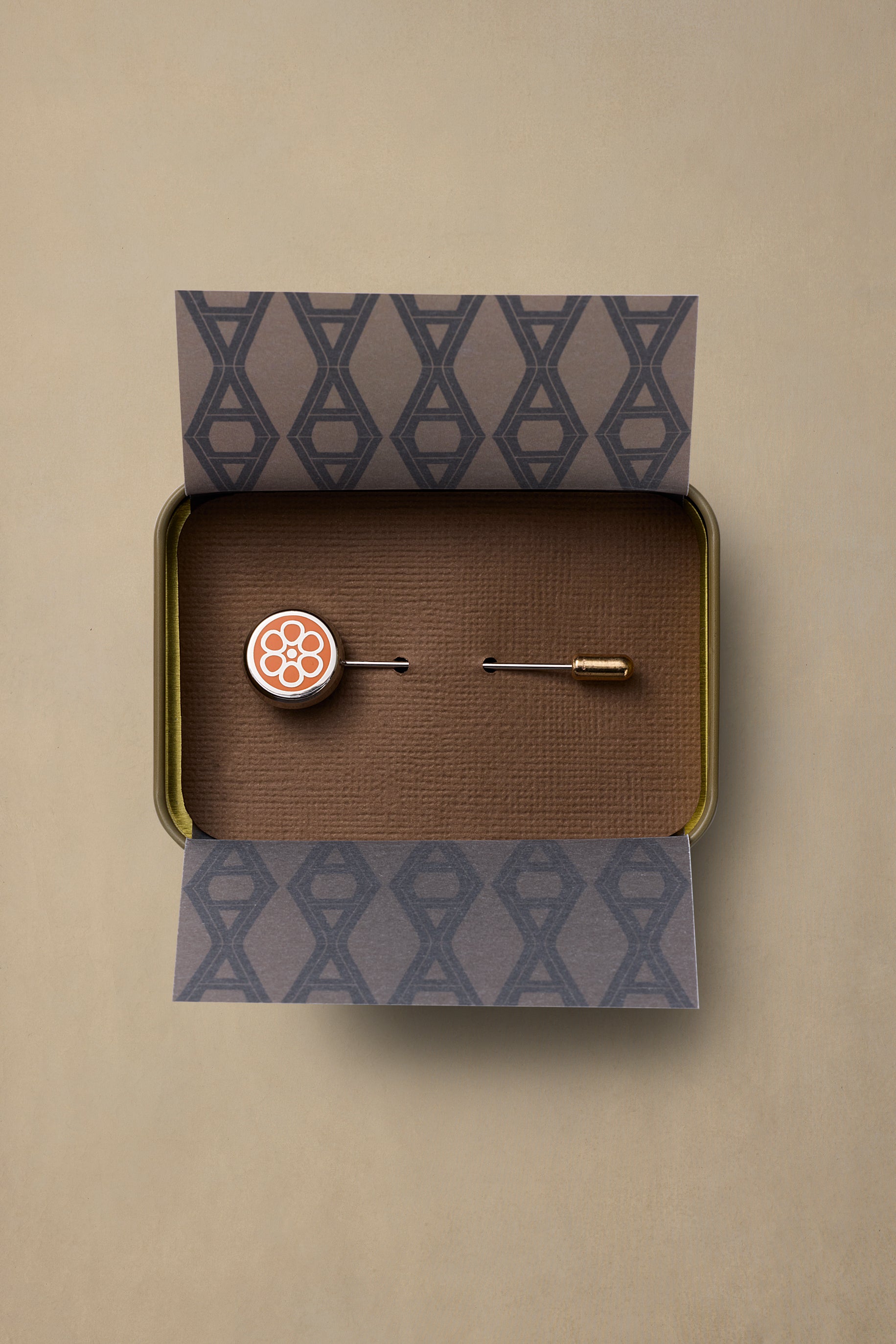 NT State pin with coral floral design in brass gift box with patterned paper packaging