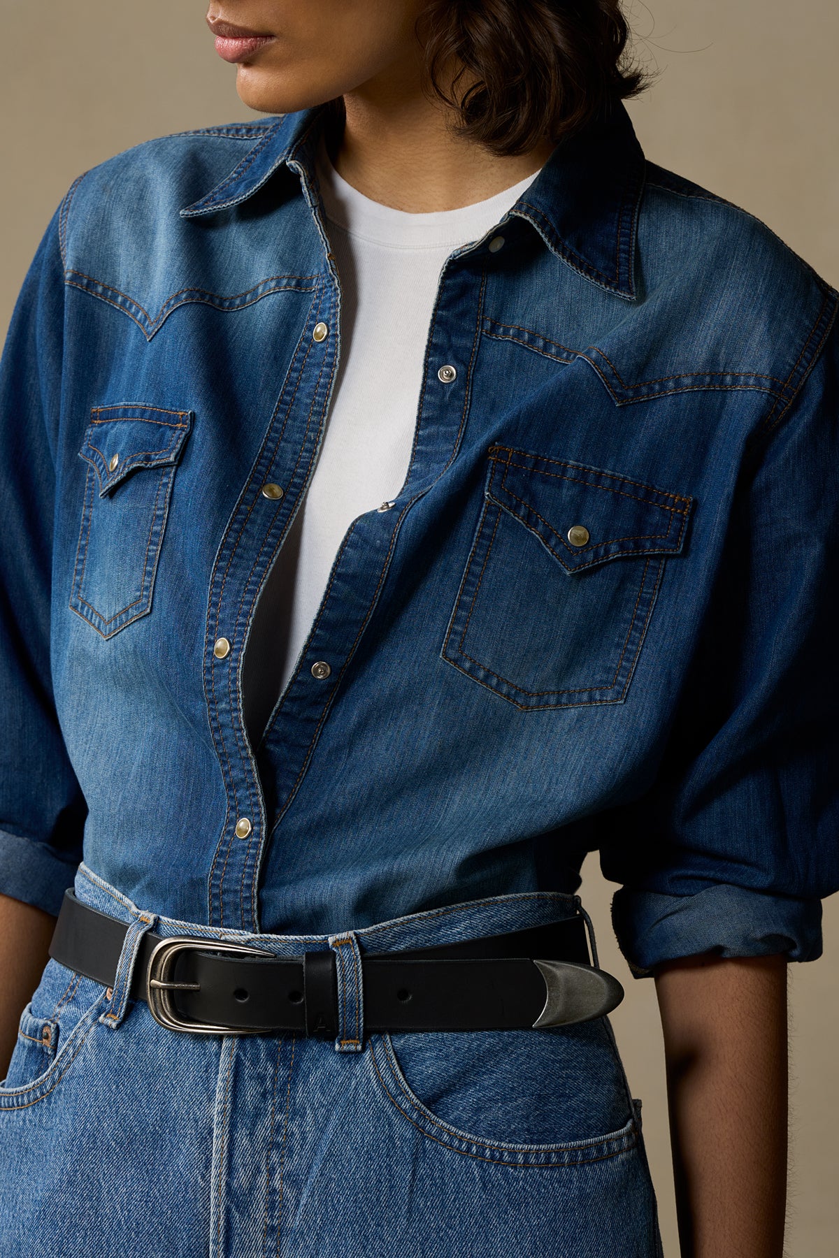 Black leather belt with pewter buckle worn with denim jacket and white shirt