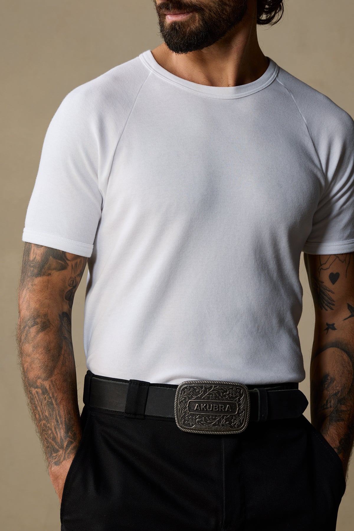 Black leather belt with ornate pewter buckle worn with white t-shirt and black pants