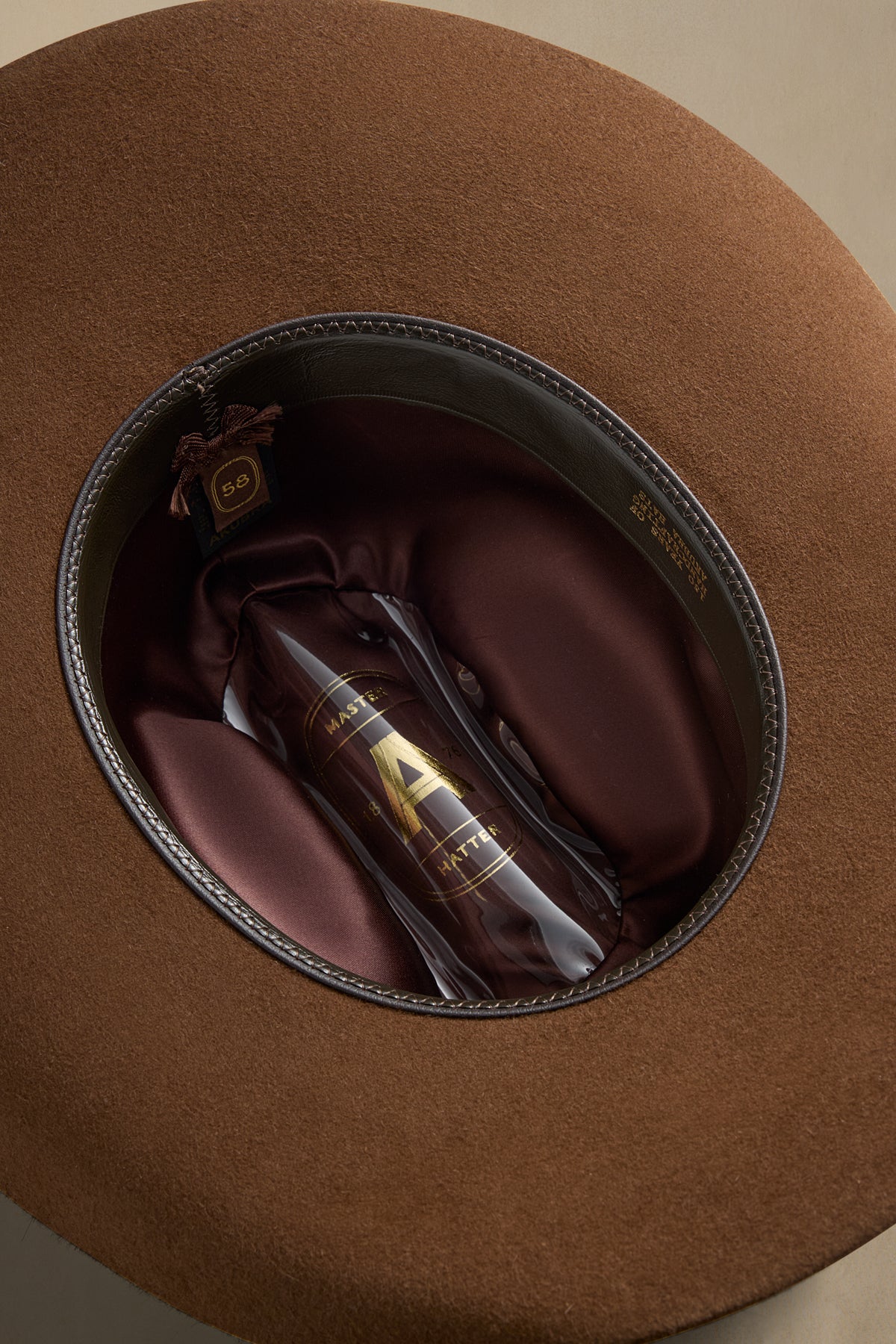 Brown fur felt Big Sky cowboy hat displayed inside its protective case with burgundy silk lining