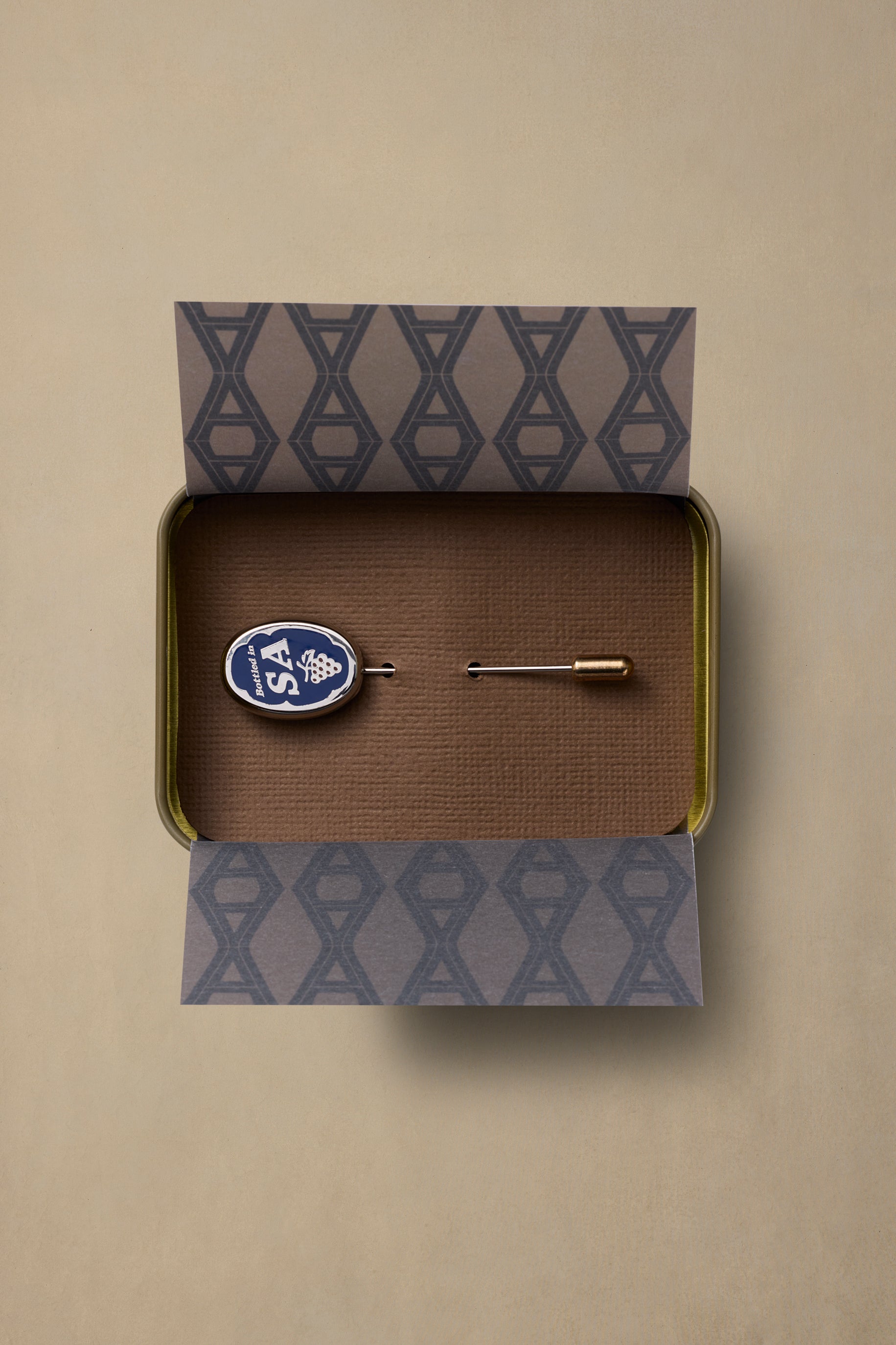 SA State pin with blue and white oval design in branded gift box with patterned tissue paper