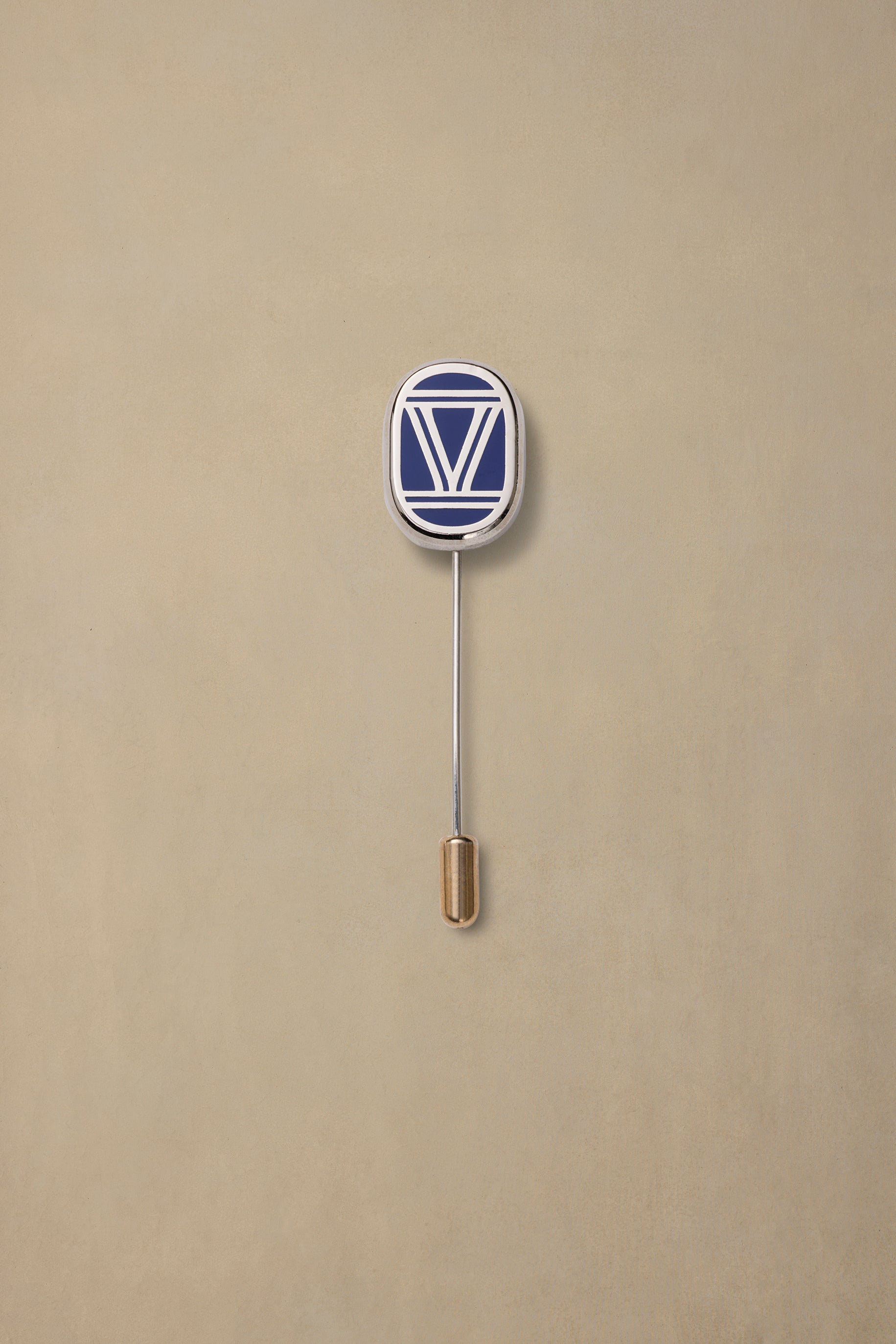 VIC State navy and white enamel pin with gold-toned backing on cream background