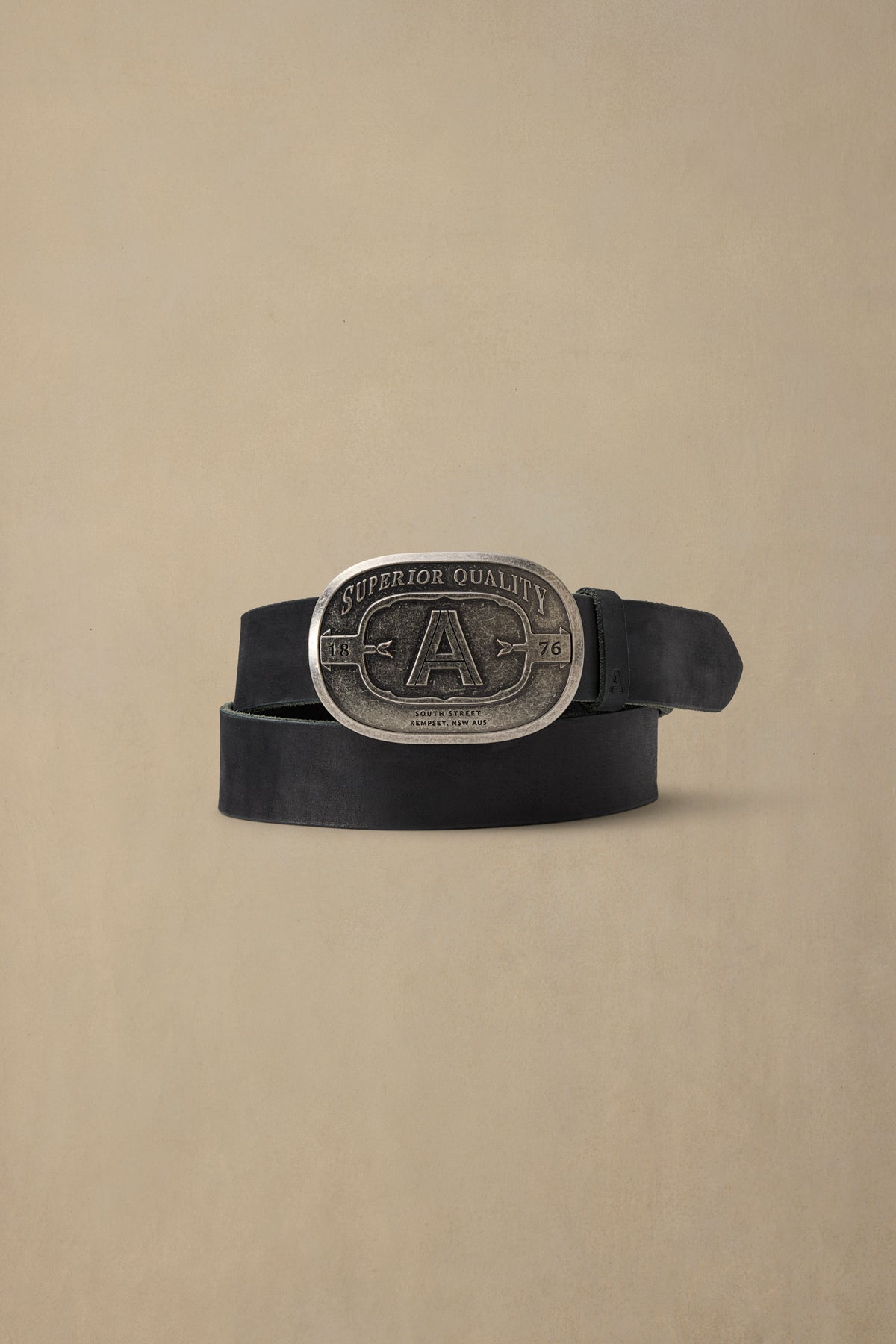 Black leather belt with silver "A" buckle featuring "Superior Quality" text and 1876 date marking against neutral background