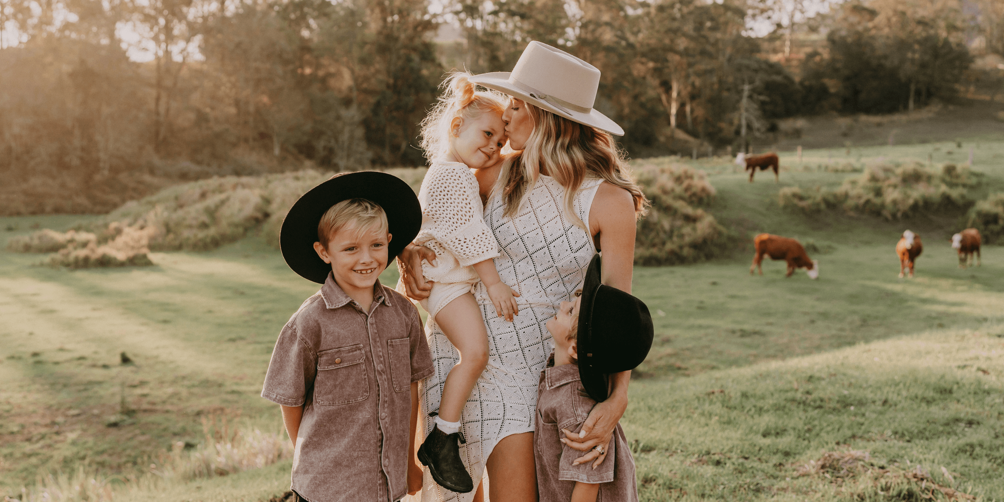 Woman holding a child, with 2 small boys next to her. They are wearing Akubra hats. Celebrate Mother's Day with Akubra.